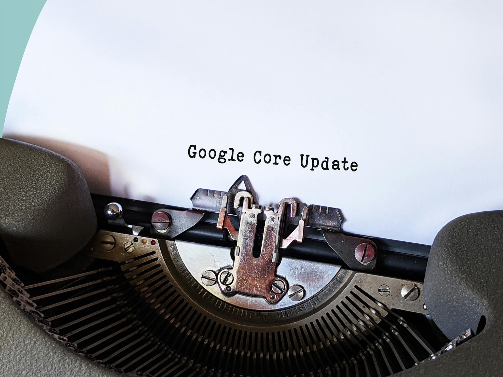 Close-up of a typewriter typing 'Google Core Update' on paper, symbolizing digital advancement.